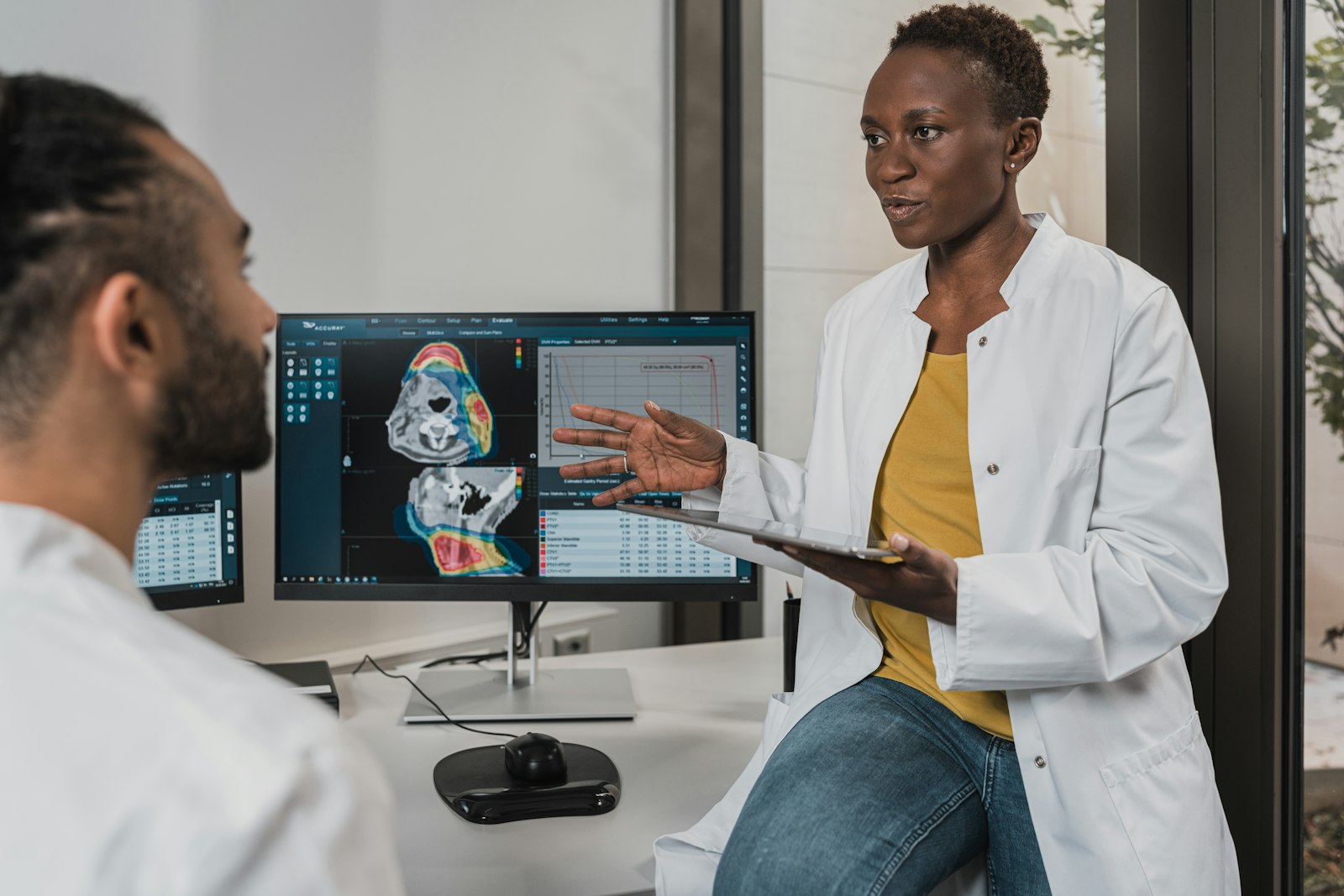 Clinicians reviewing medical imaging at a workstation