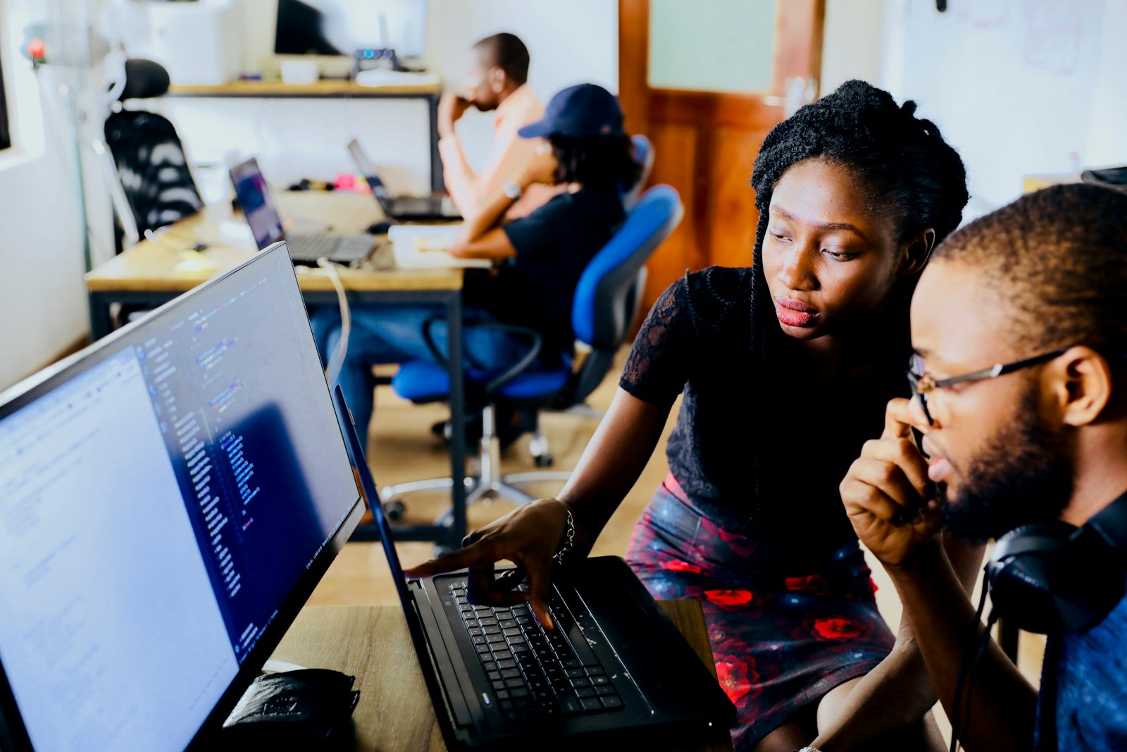 Two engineers reviewing code together